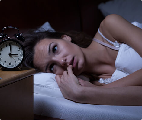 Image of woman unable to fall asleep.